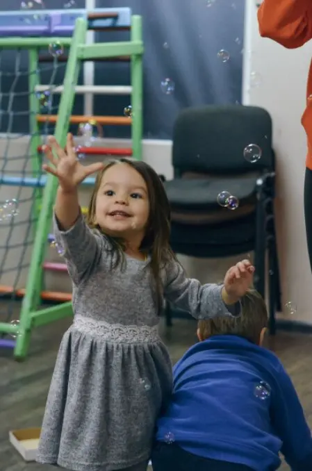 Warm, home-like daycare play area with toys neatly arranged
